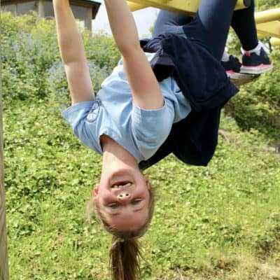 Ruby upside down monkey bars looking at camera